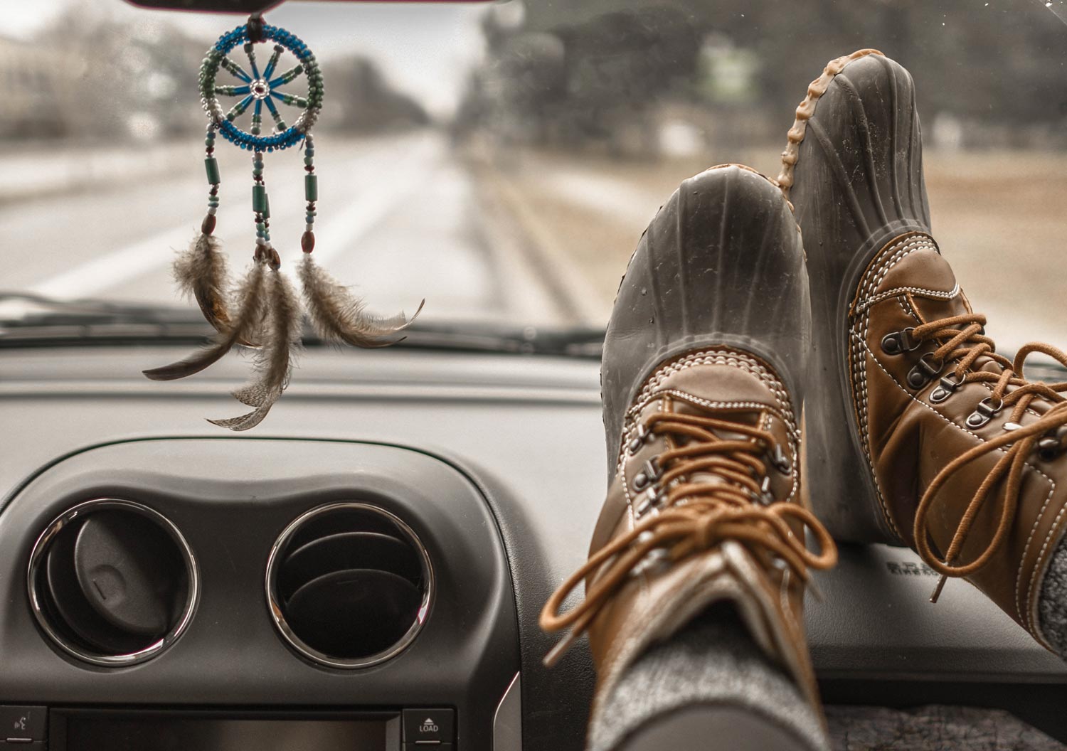 rain boots on car dashboard
